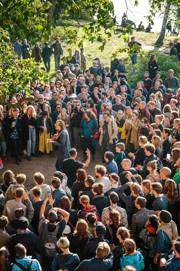 Sunlit outdoor gathering between studios